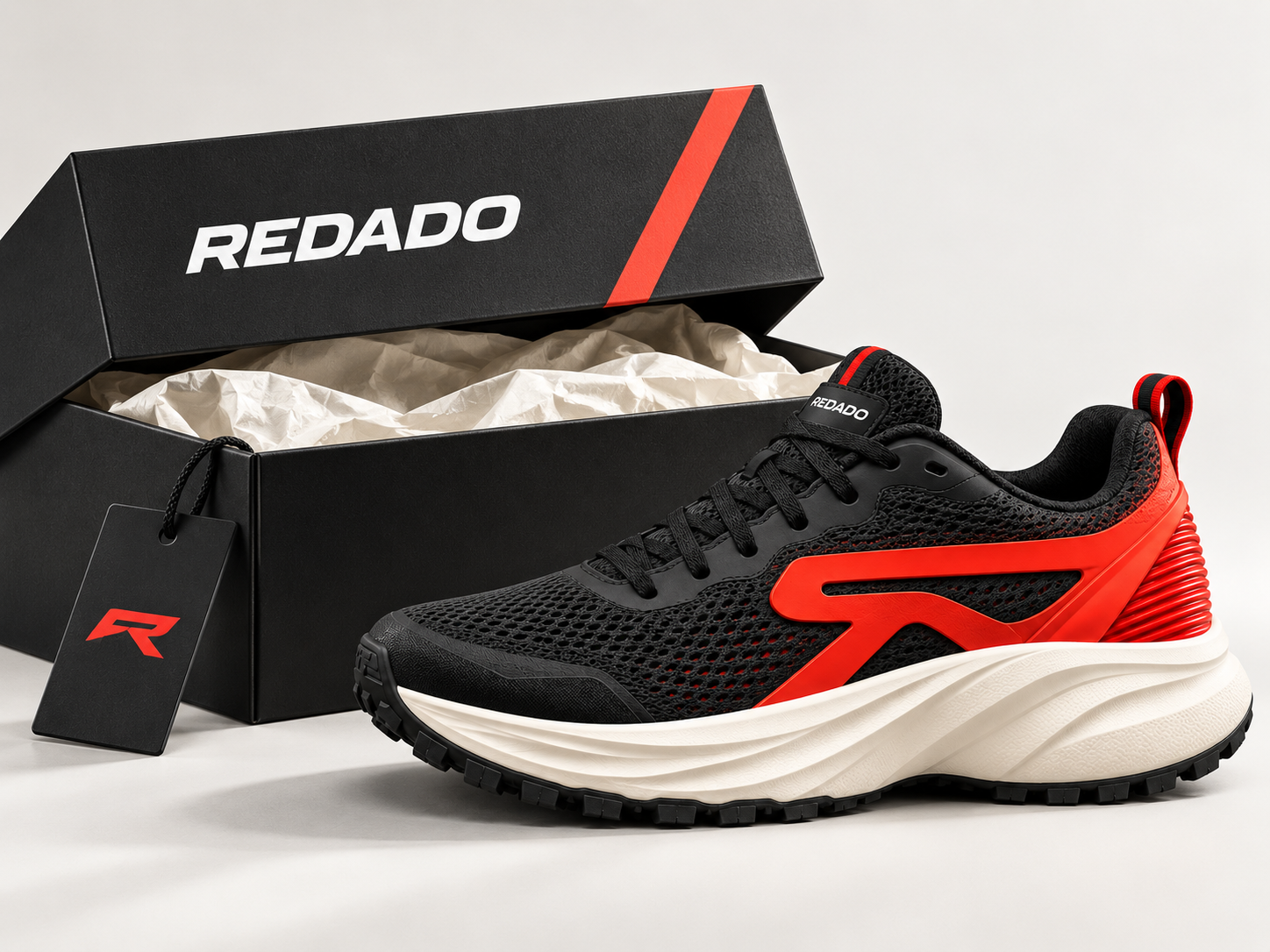 Illustrative REDADO black shoebox, tissue, hangtag and black-red Daily sneaker.